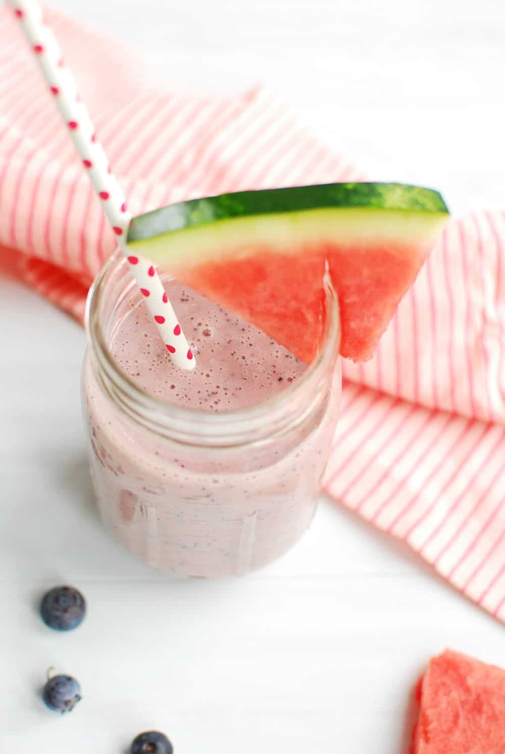 Overhead shot of a blueberry watermelon smoothie in a mason jar