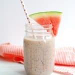 Watermelon blueberry smoothie with a slice of watermelon on the rim