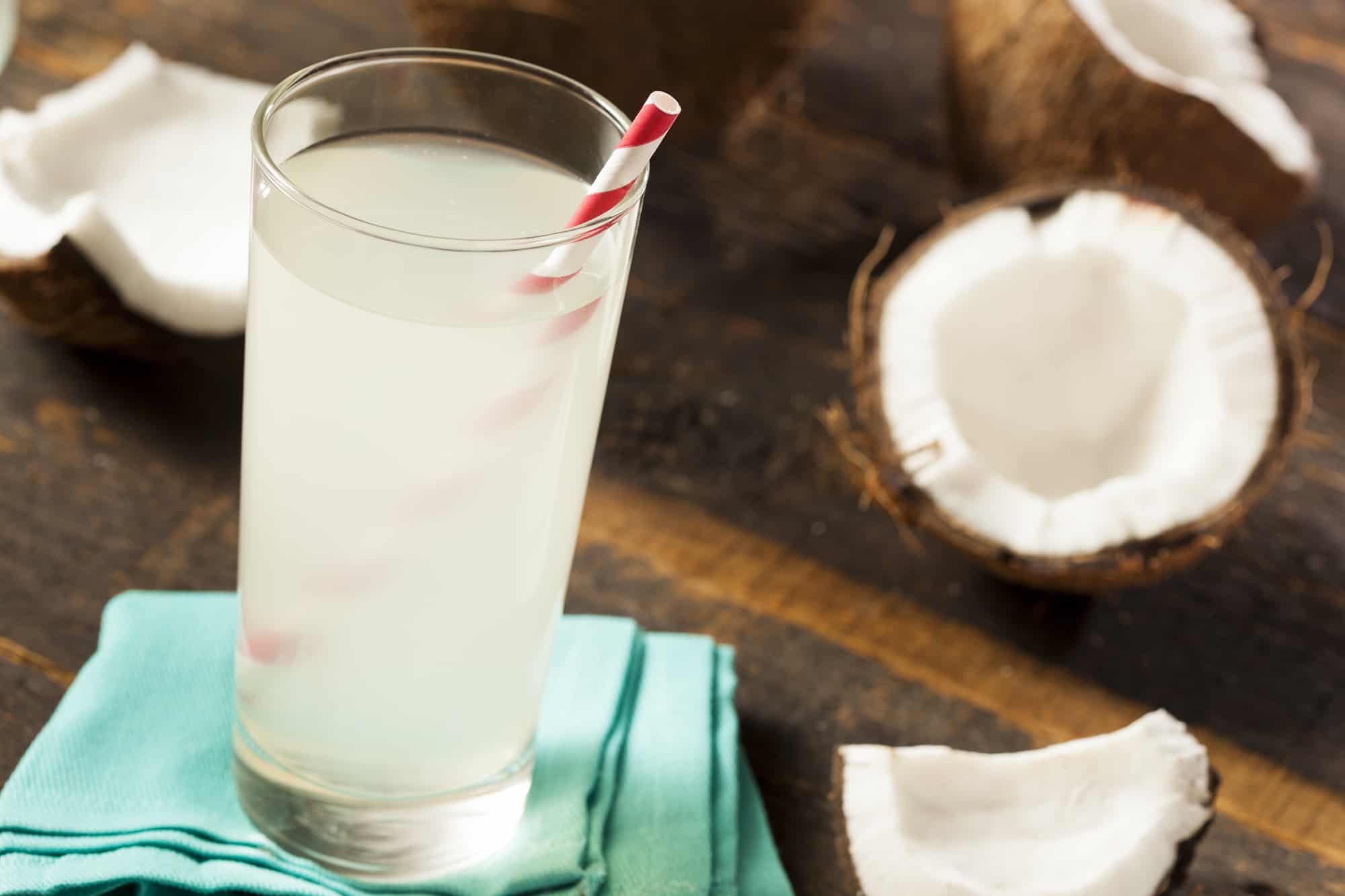 Fresh Organic Coconut Water for Runners Next to a Coconut