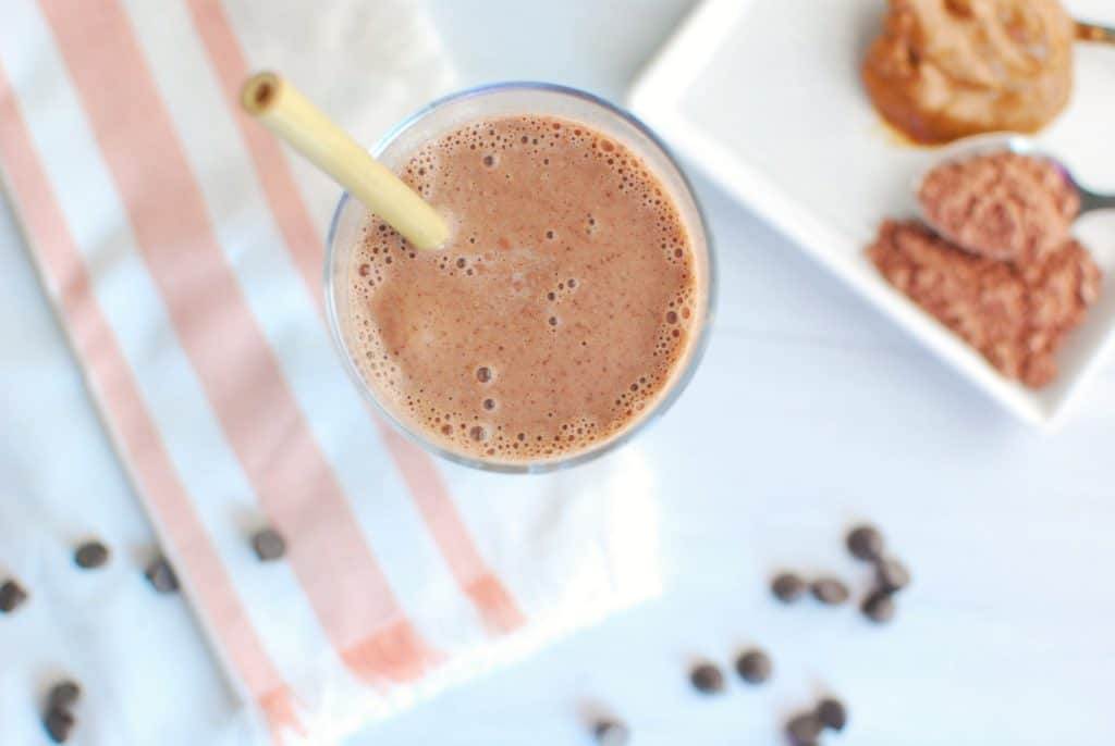 Close up of a cacao almond butter smoothie in a glass