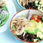 Bowl of carnitas salad with pork, tomatoes, corn, and beans