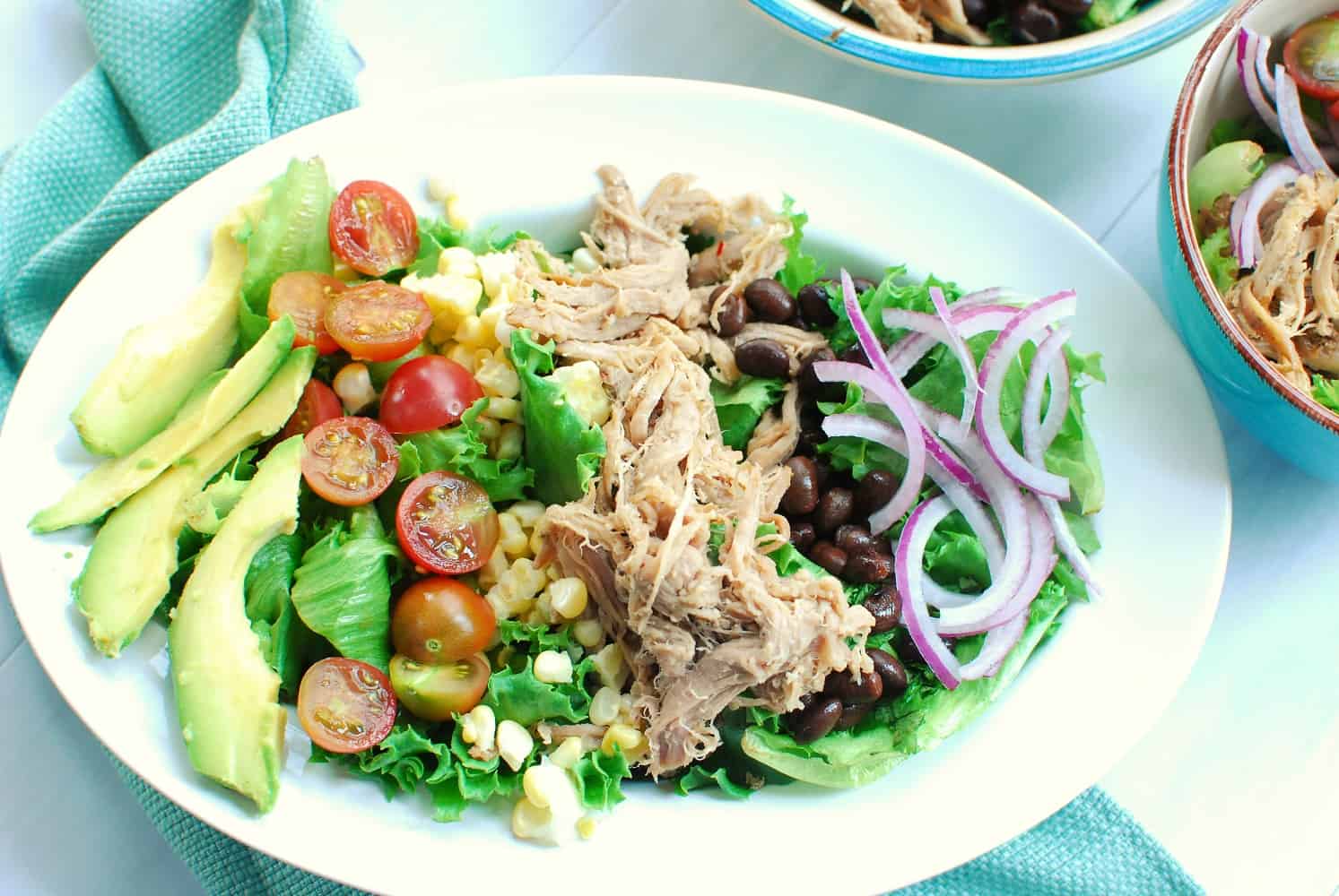 Bowl of carnitas salad with salsa verde dressing