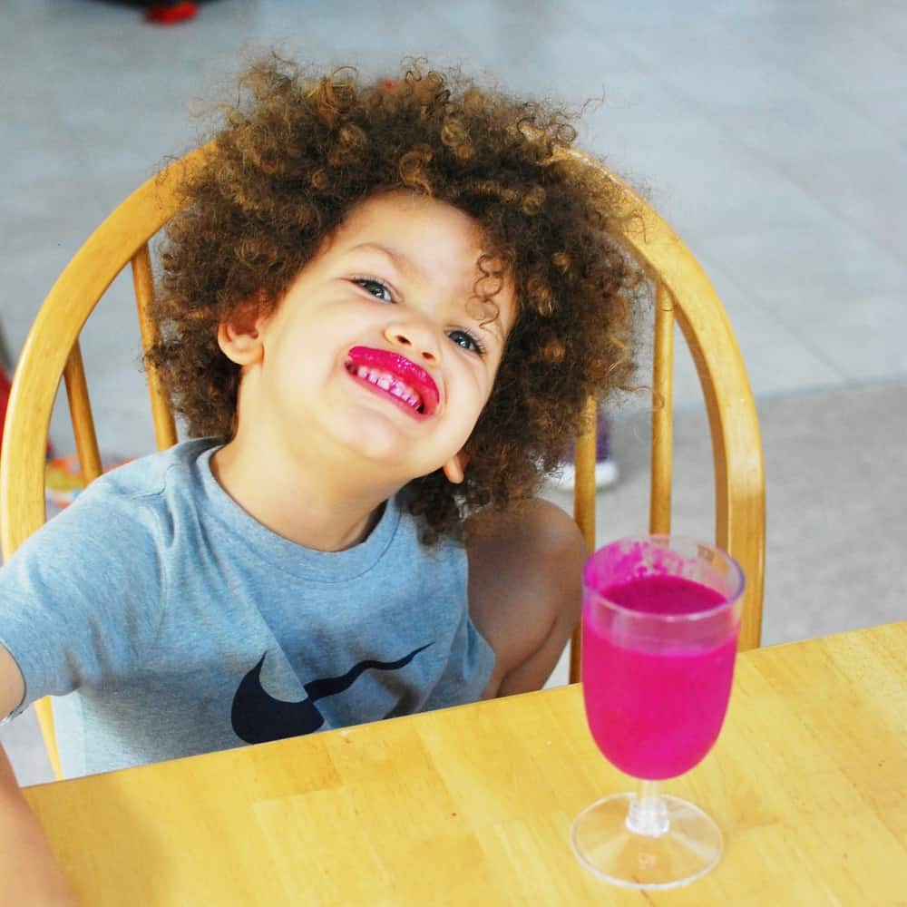 Child drinking dragon fruit smoothie