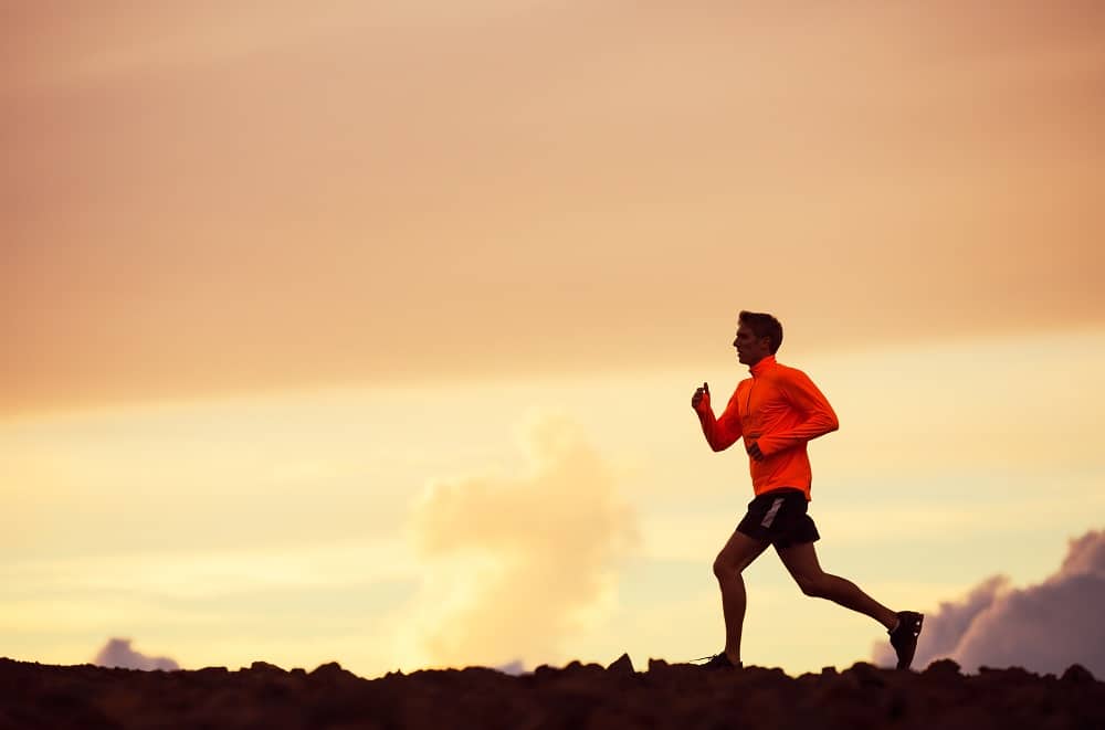 Man training for a half marathon during sunset