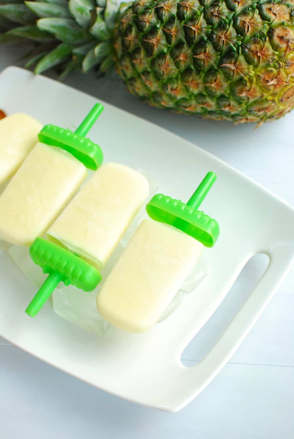 Pina Colada Popsicles on a tray