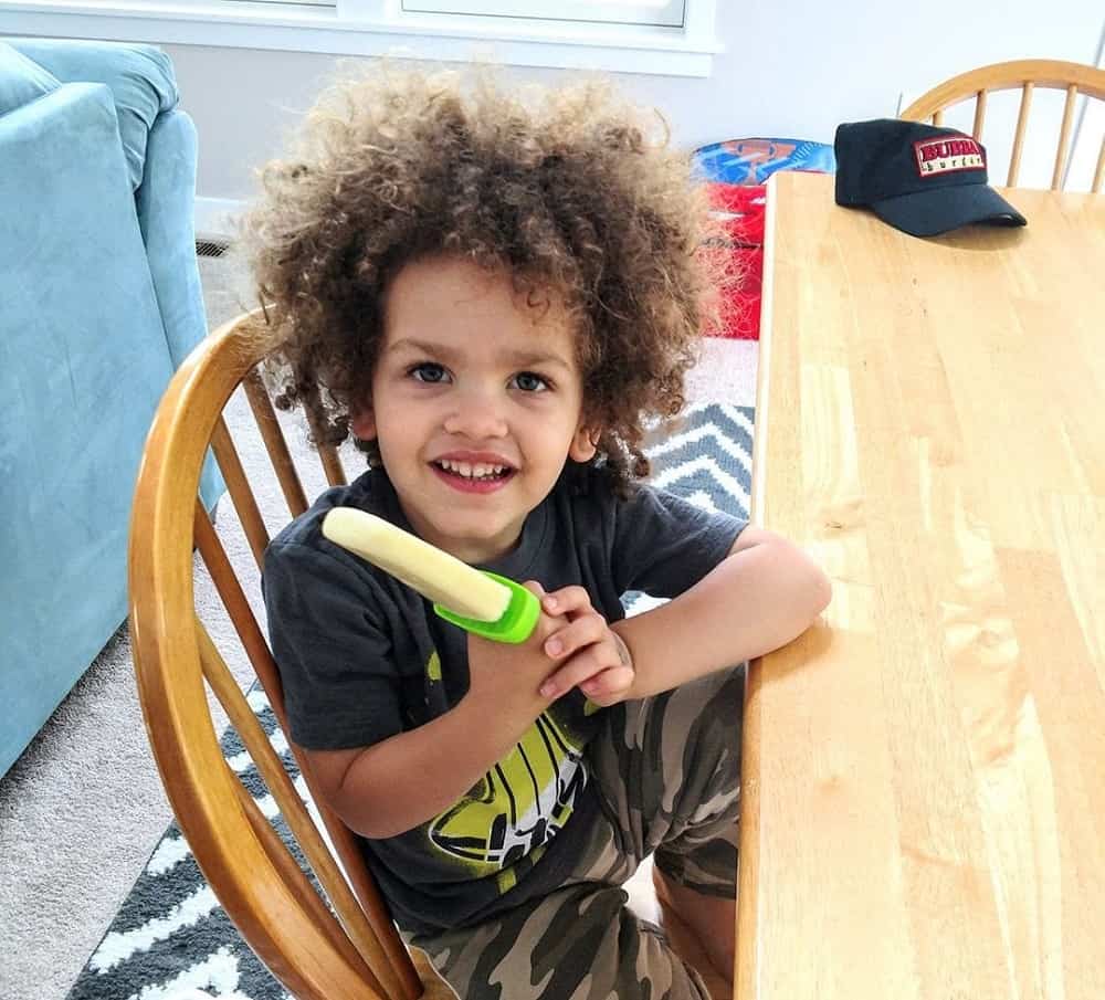 Child eating homemade pineapple popsicles