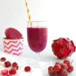 Dragon fruit smoothie in a glass with a straw