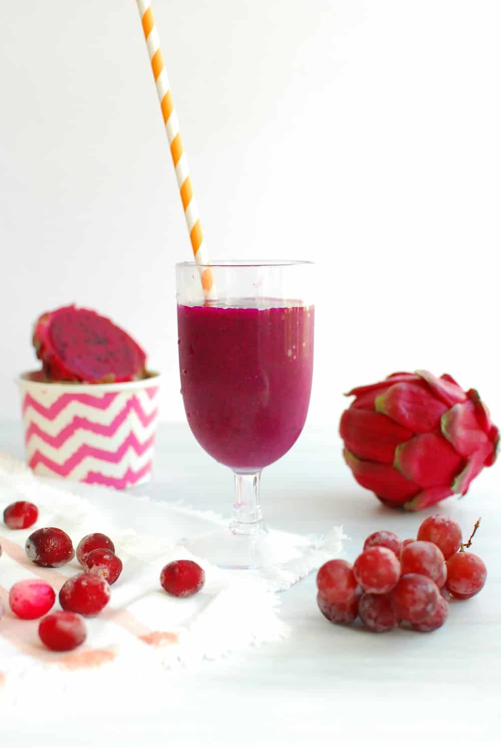 Dragon fruit smoothie in a glass with a straw