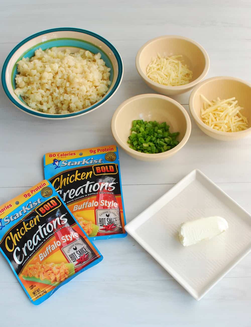 Ingredients to make a buffalo chicken cauliflower rice casserole