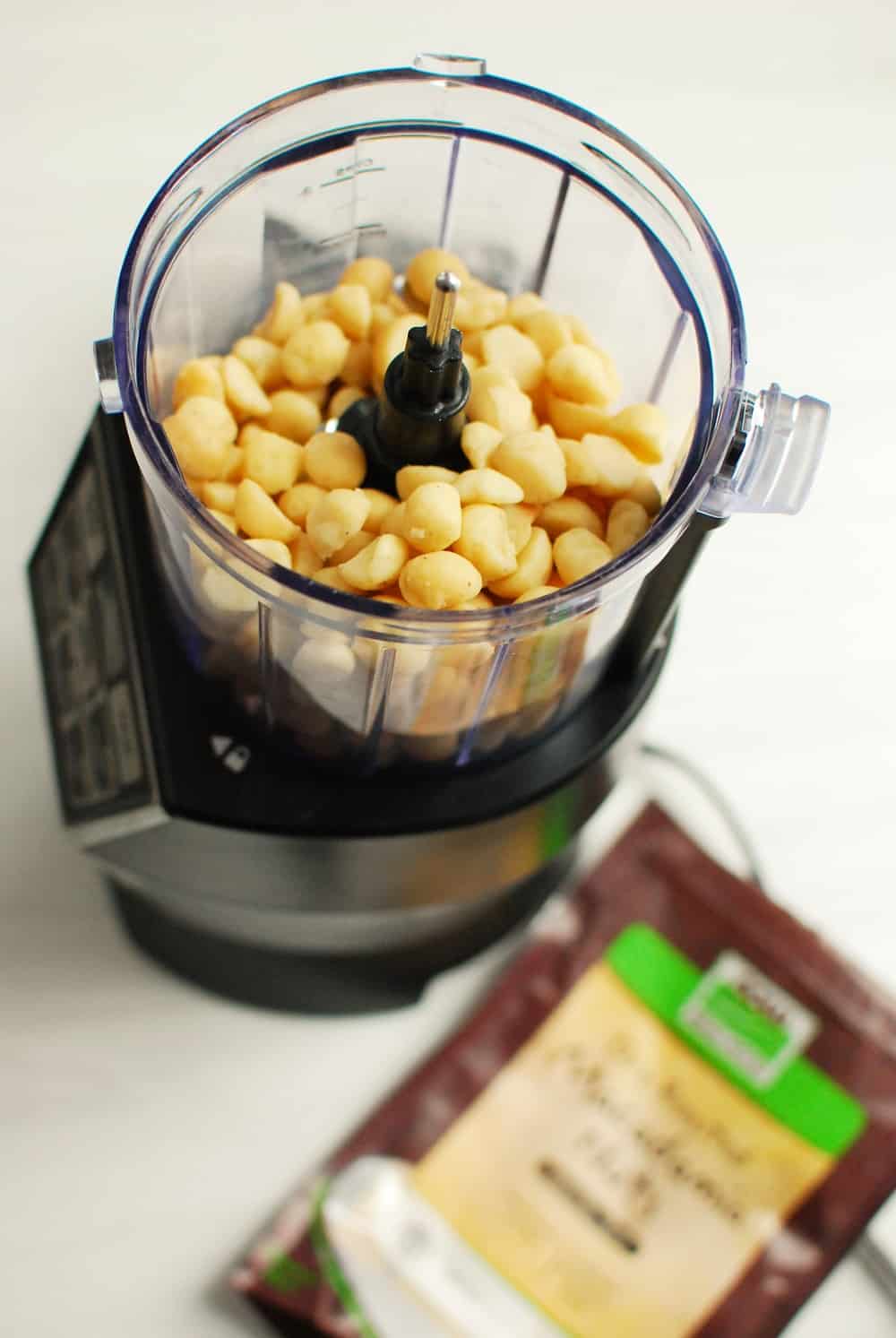 A food processor full of macadamia nuts