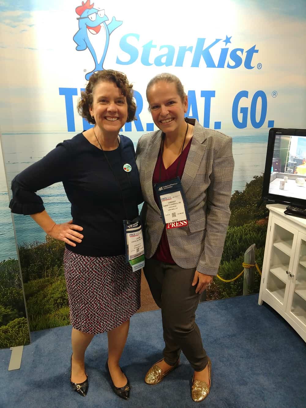 Two dietitians meeting at the StarKist booth at FNCE