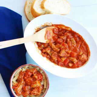 A dish full of veal marengo next to a bowl of pasta topped with this french veal stew