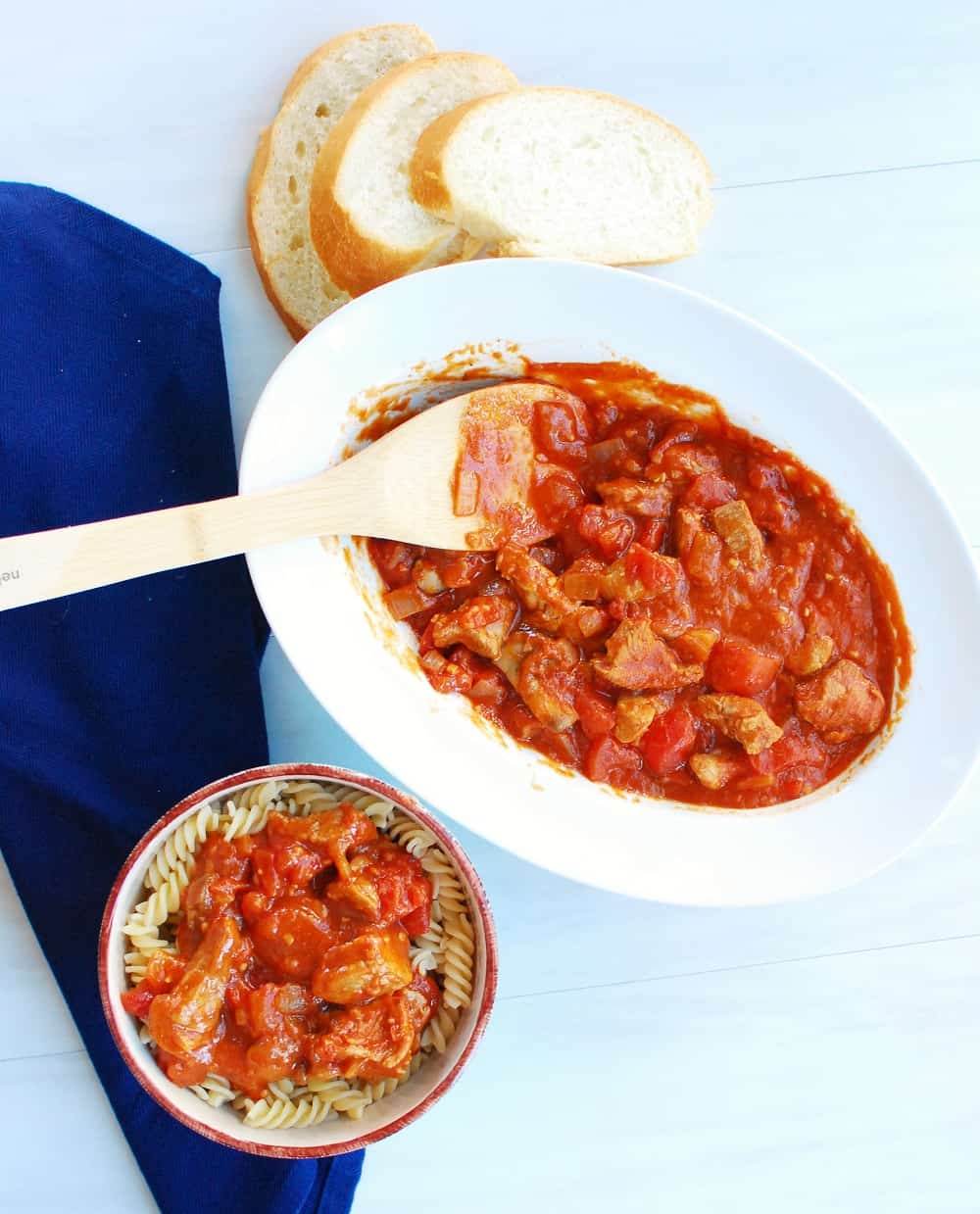 A dish full of veal marengo next to a bowl of pasta topped with this french veal stew