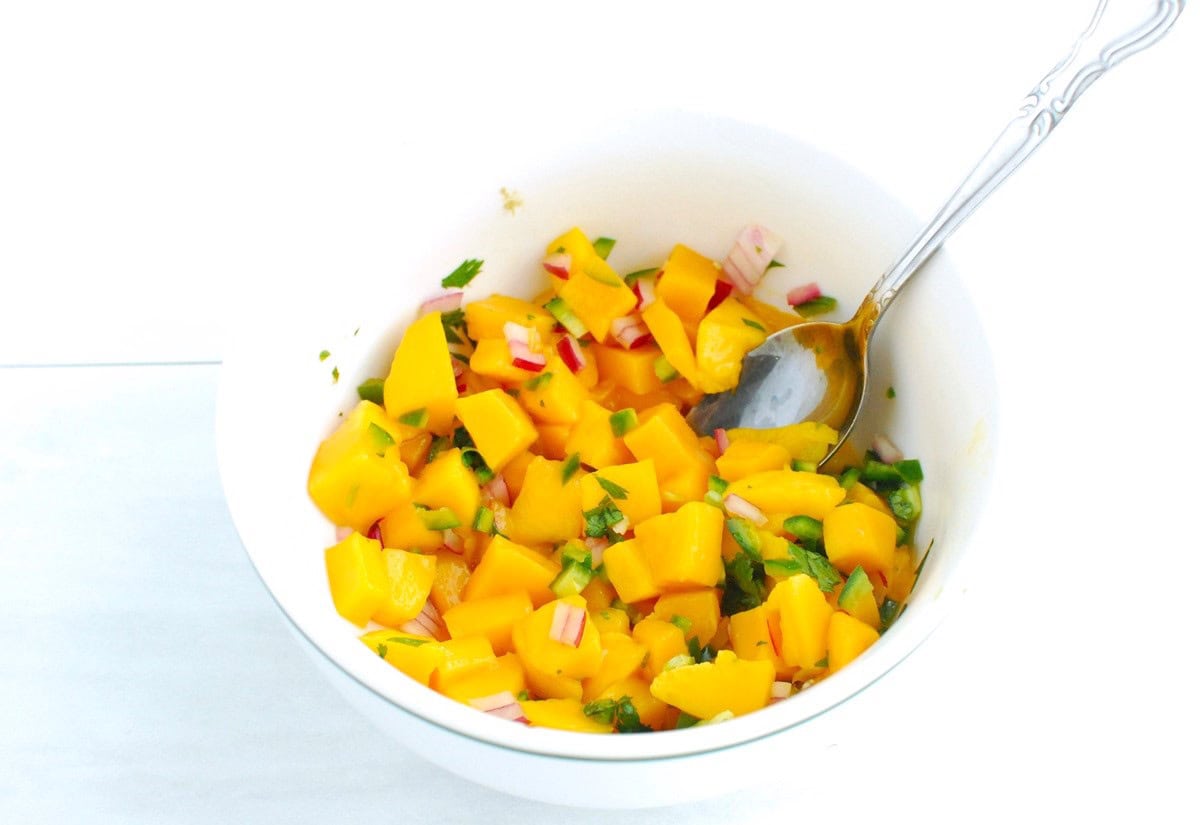Mango salsa in a white bowl.