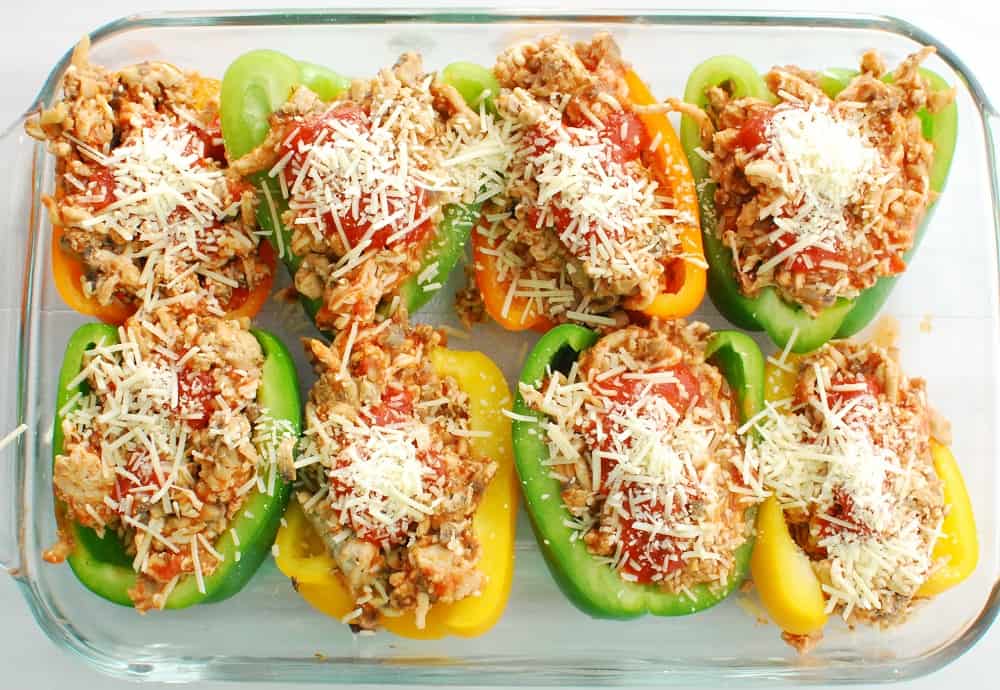 Casserole dish of chicken stuffed peppers ready to go in the oven