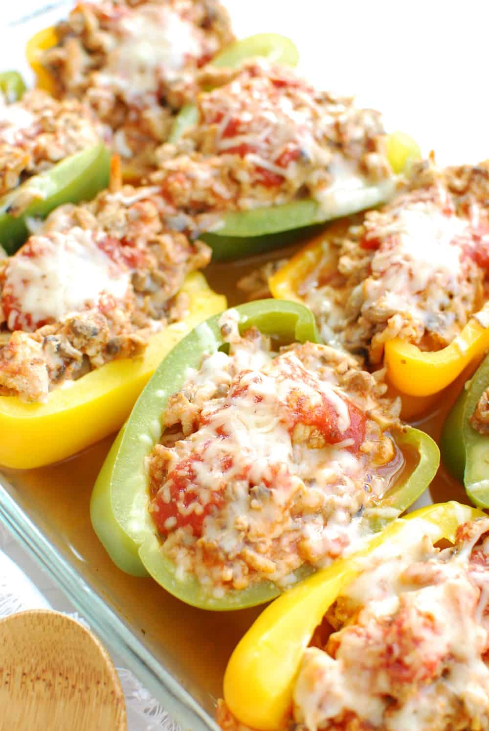 A casserole dish with cooked chicken stuffed peppers