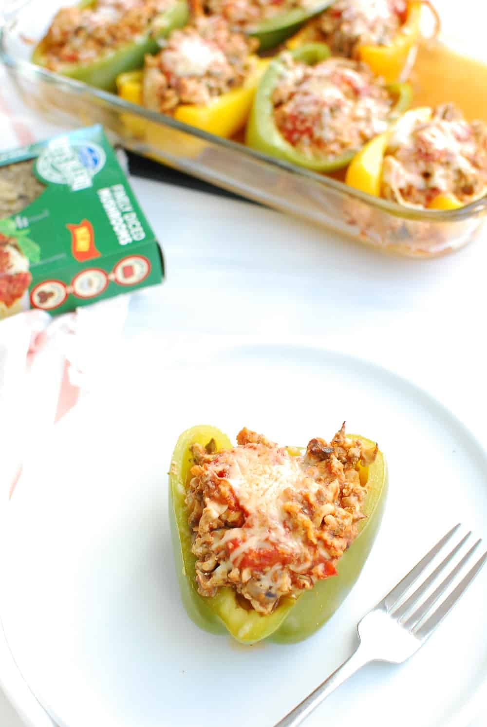 A chicken parm stuffed pepper on a white plate