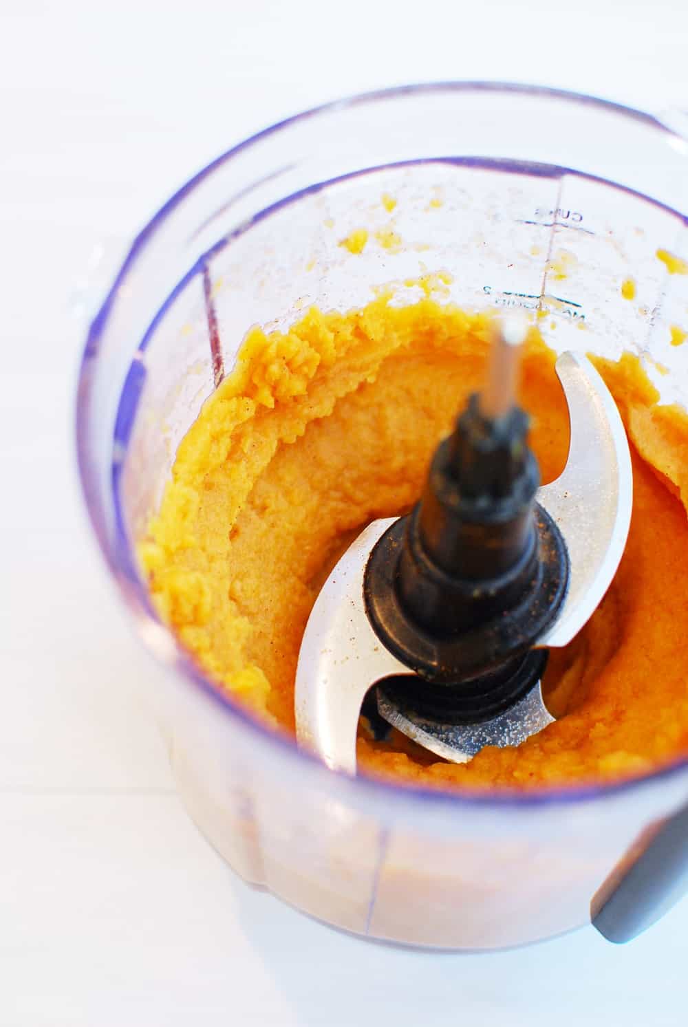 sweet potato in a food processor with cinnamon and almond milk