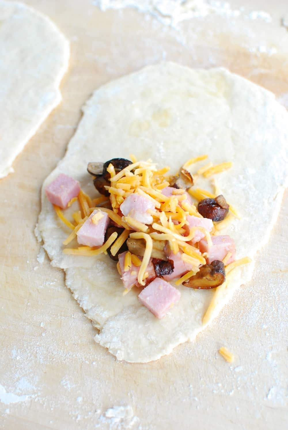 Placing homemade hot pocket filling in the dough