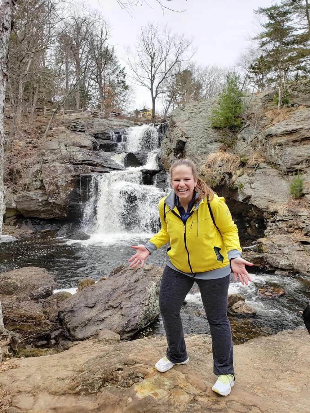 A woman hiking at Devil's Hopyard during a connecticut getaway