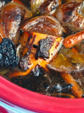A slow cooker with homemade bone broth before being strained.