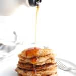 A stack of low calorie pancakes with maple syrup drizzled on top.