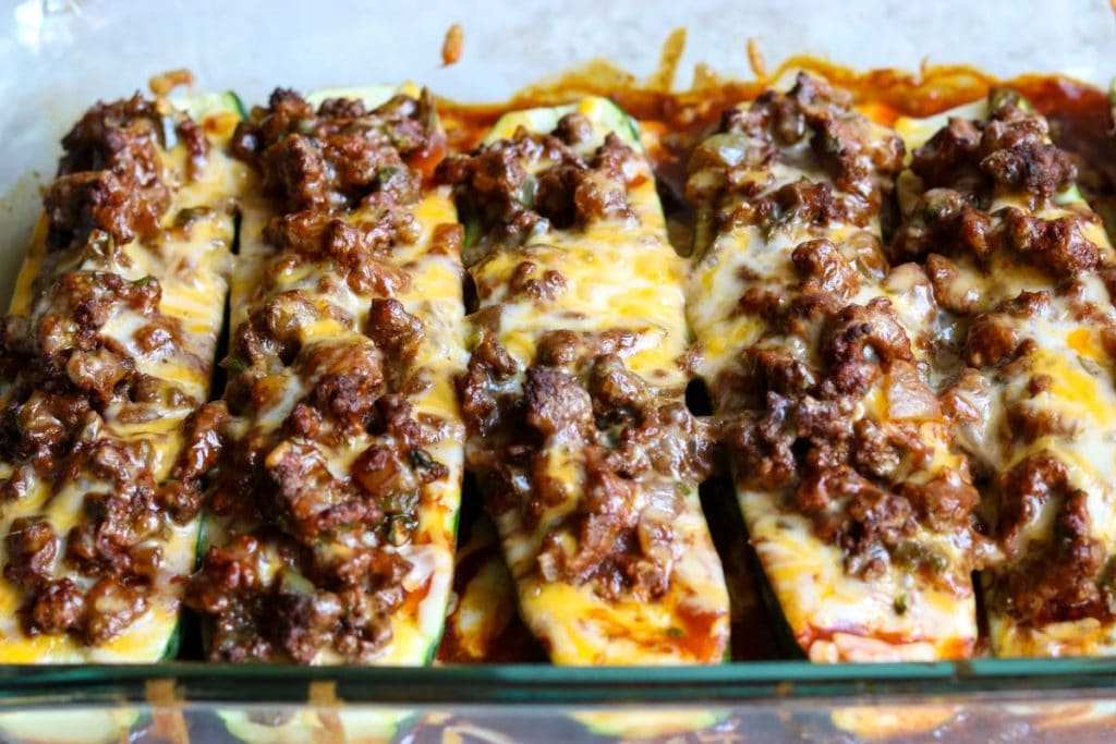 Zucchini enchilda boats in a glass casserole dish.