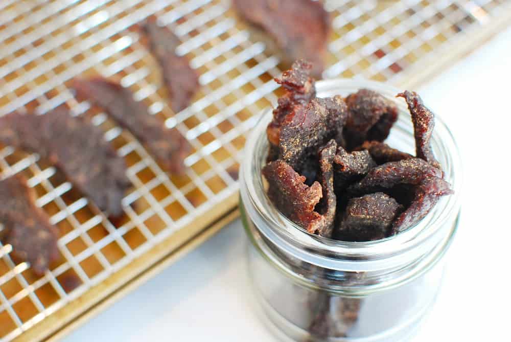 Several pieces of gluten free beef jerky in a small jar