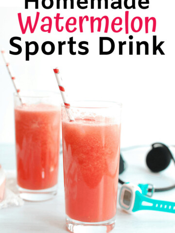 Two glasses filled with homemade sports drink next to a watch and headphones