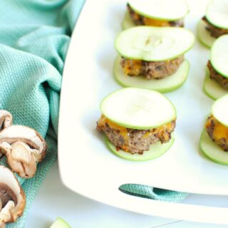 a white platter full of apple burgers