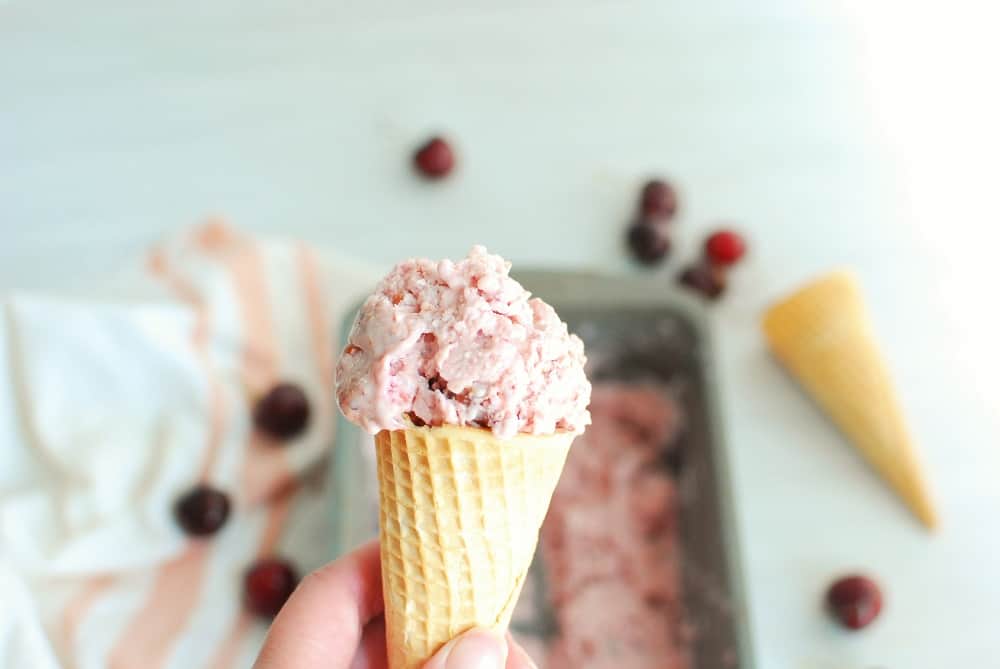 A cone of cherry vanilla ice cream.