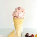 a sugar cone of cherry vanilla ice cream
