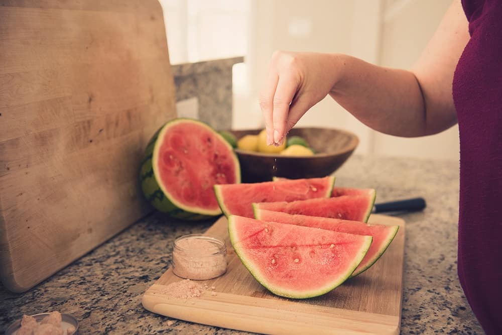 Sprinkling watermelon with sea salt