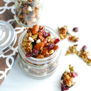 Fall trail mix in a jar next to a spoon of spilled trail mix