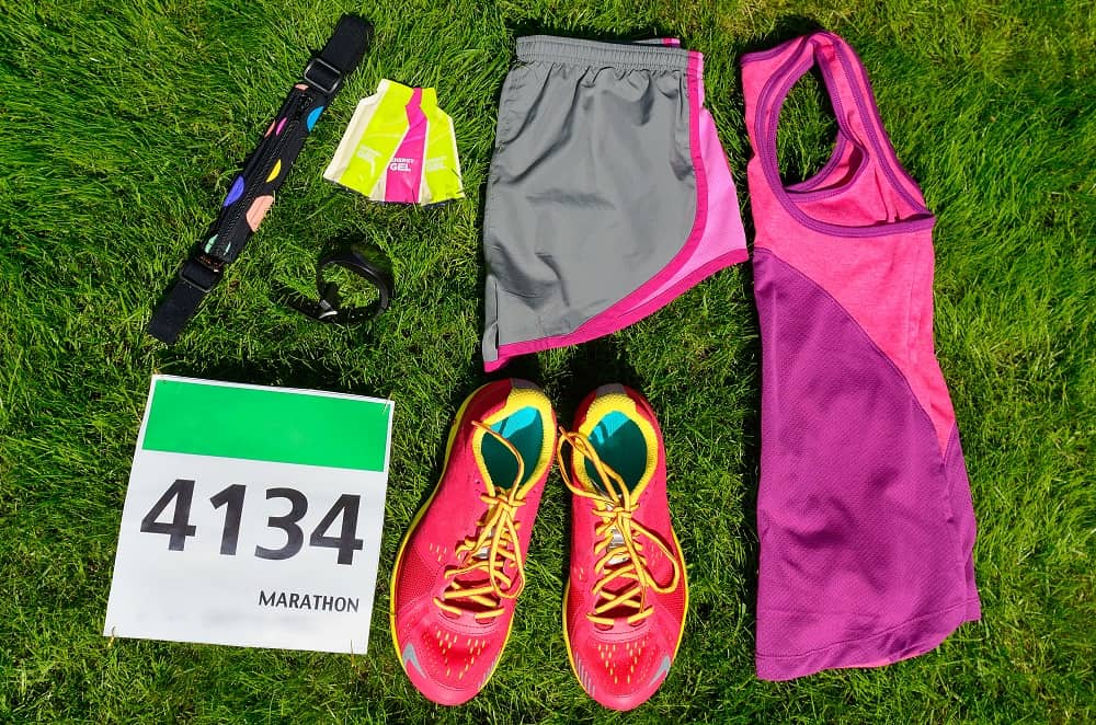 A flatlay of gear for a marathon including energy gels as a source of carbs