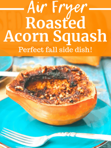 Air fryer acorn squash on a plate next to a fork