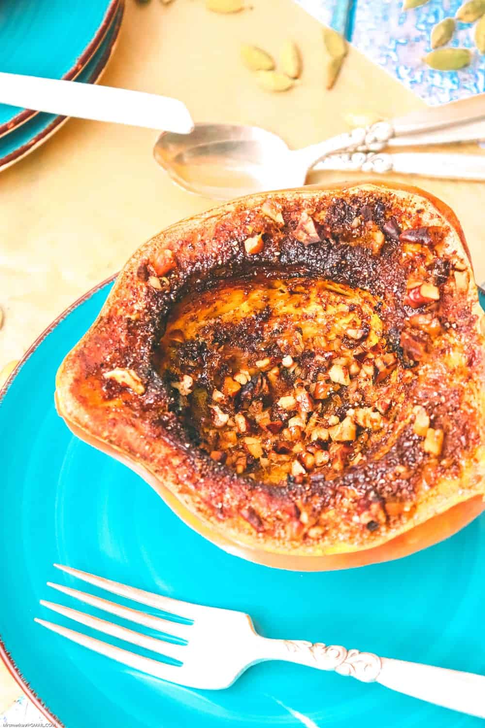 air fryer squash on a plate topped with sugar cinnamon and pecans