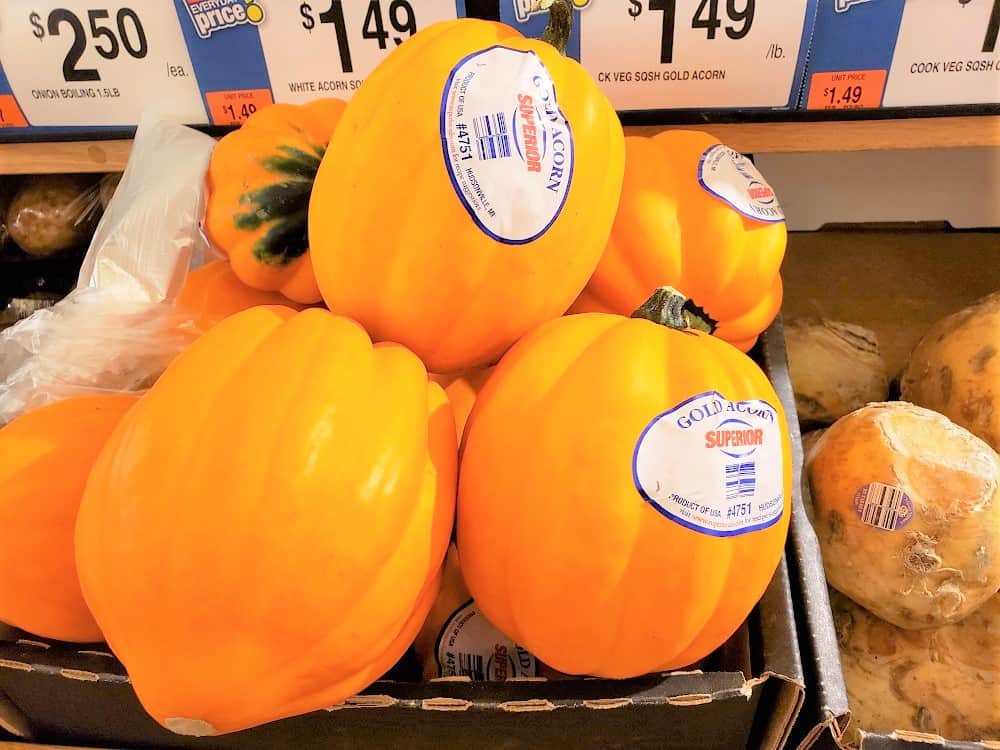 Golden acorn squash in a produce bin