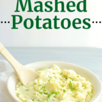 Greek yogurt mashed potatoes with chives in a serving bowl.