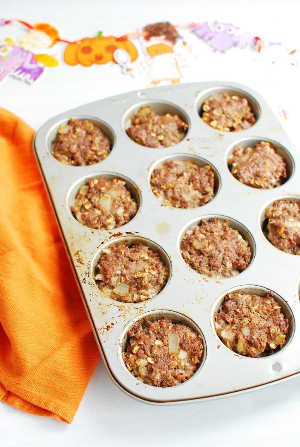 Mini meatloaves in a muffin tin after they've finished cooking