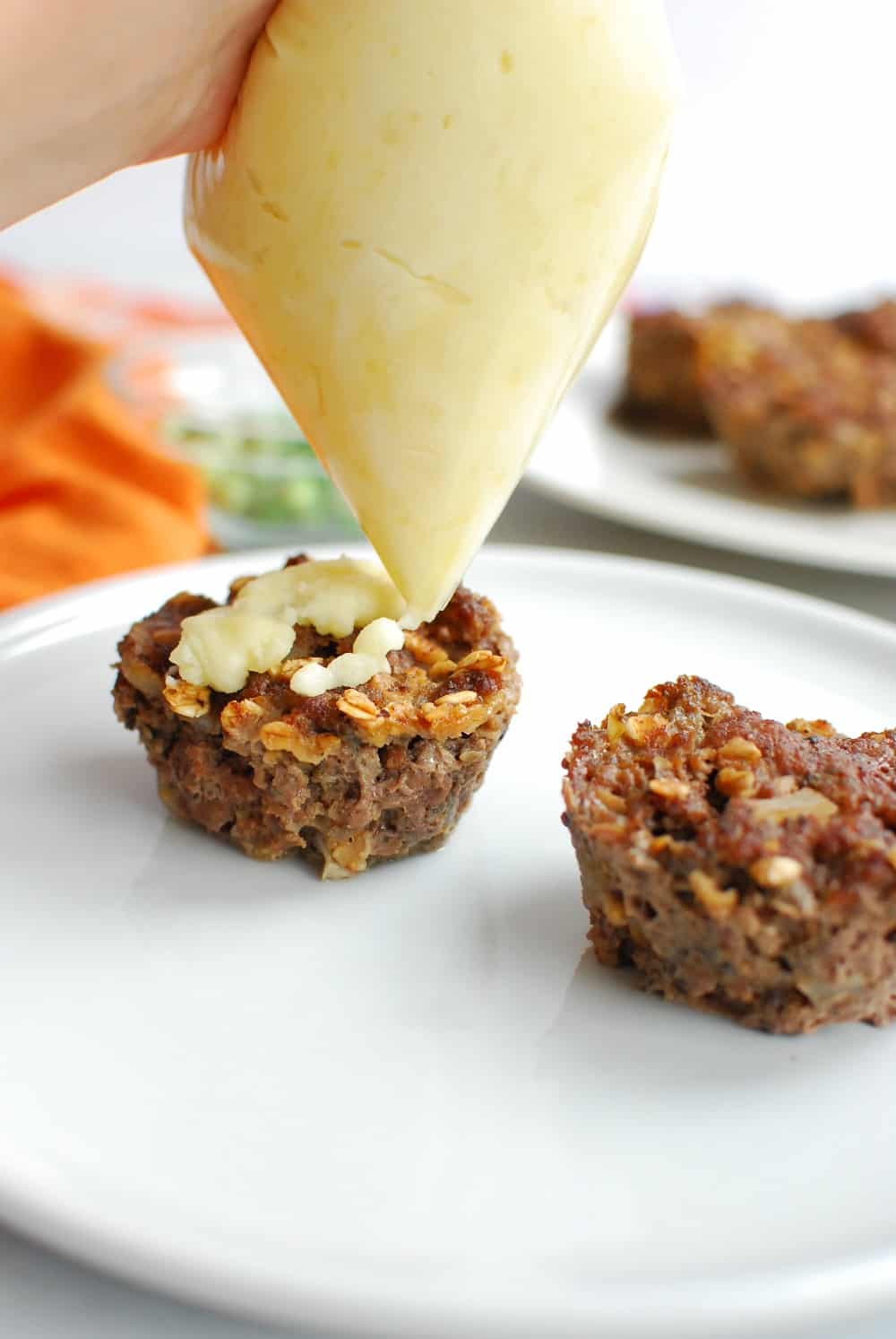 Piping mashed potato filling onto the Halloween meatloaf