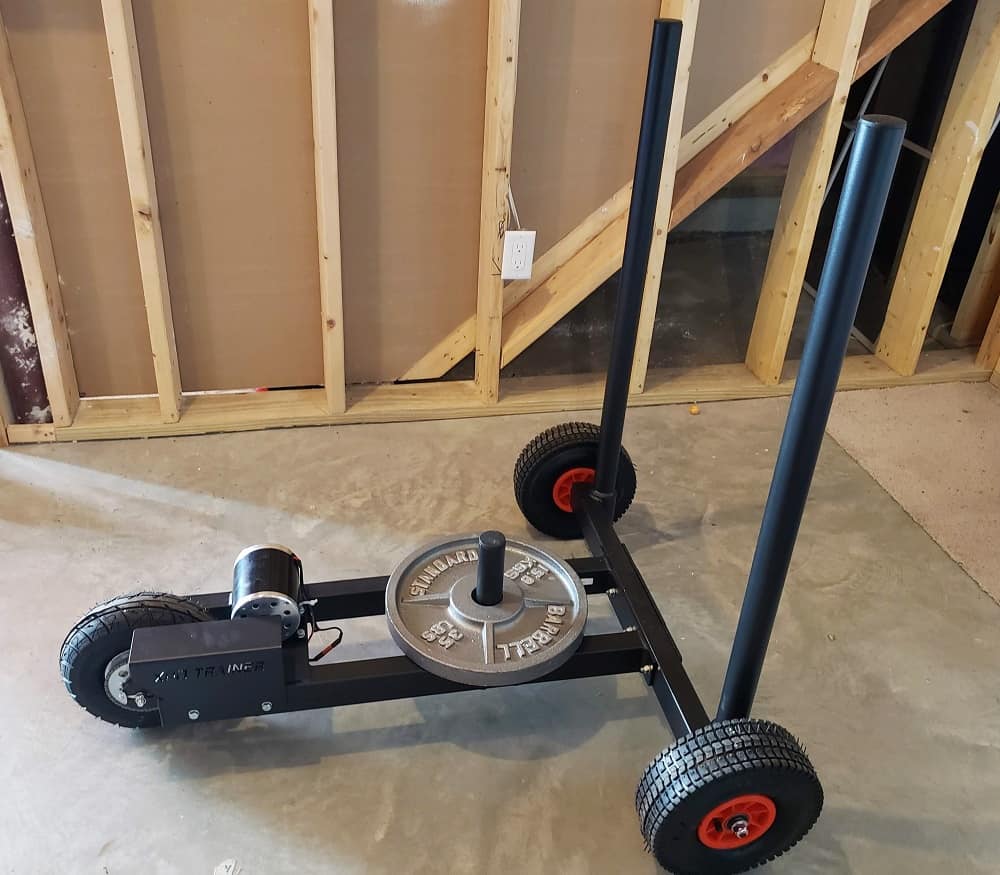 An Armored Fitness push sled in a basement.