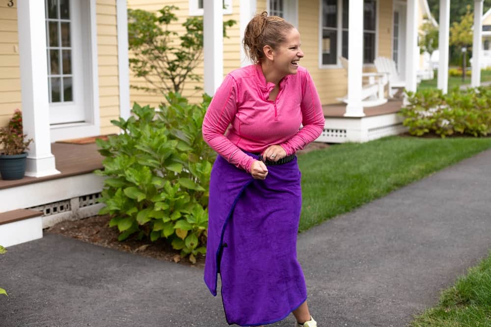 A woman using the orange mud changing wrap.