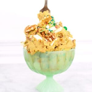 A bowl of chickpea cookie dough hummus with a fork stuck in the top.