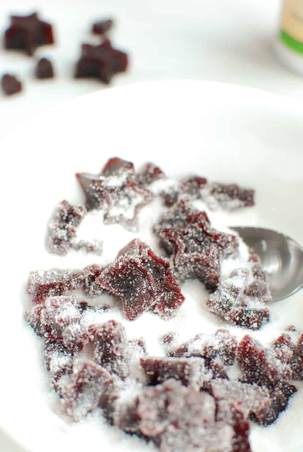 mixing gummies in sugar and citric acid for a sour coating