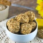 a bowl full of peanut butter banana oat balls on a wooden table