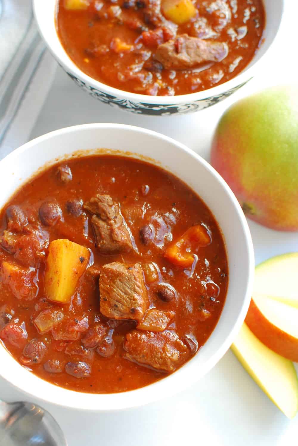 two bowls full of steak and mango chili