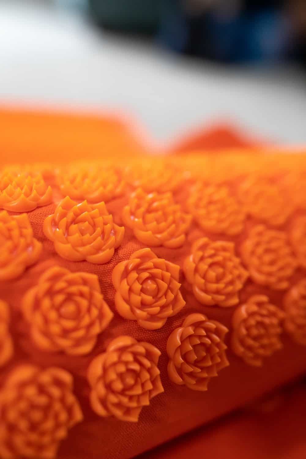 an acupressure pillow with hard plastic flowers