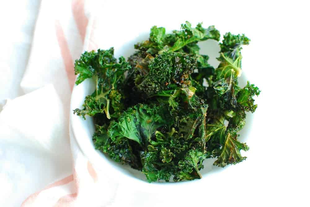 a bowl full of cooked kale chips