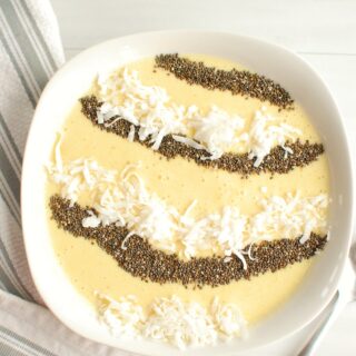 high fiber smoothie bowl topped with chia seeds and coconut, next to a spoon